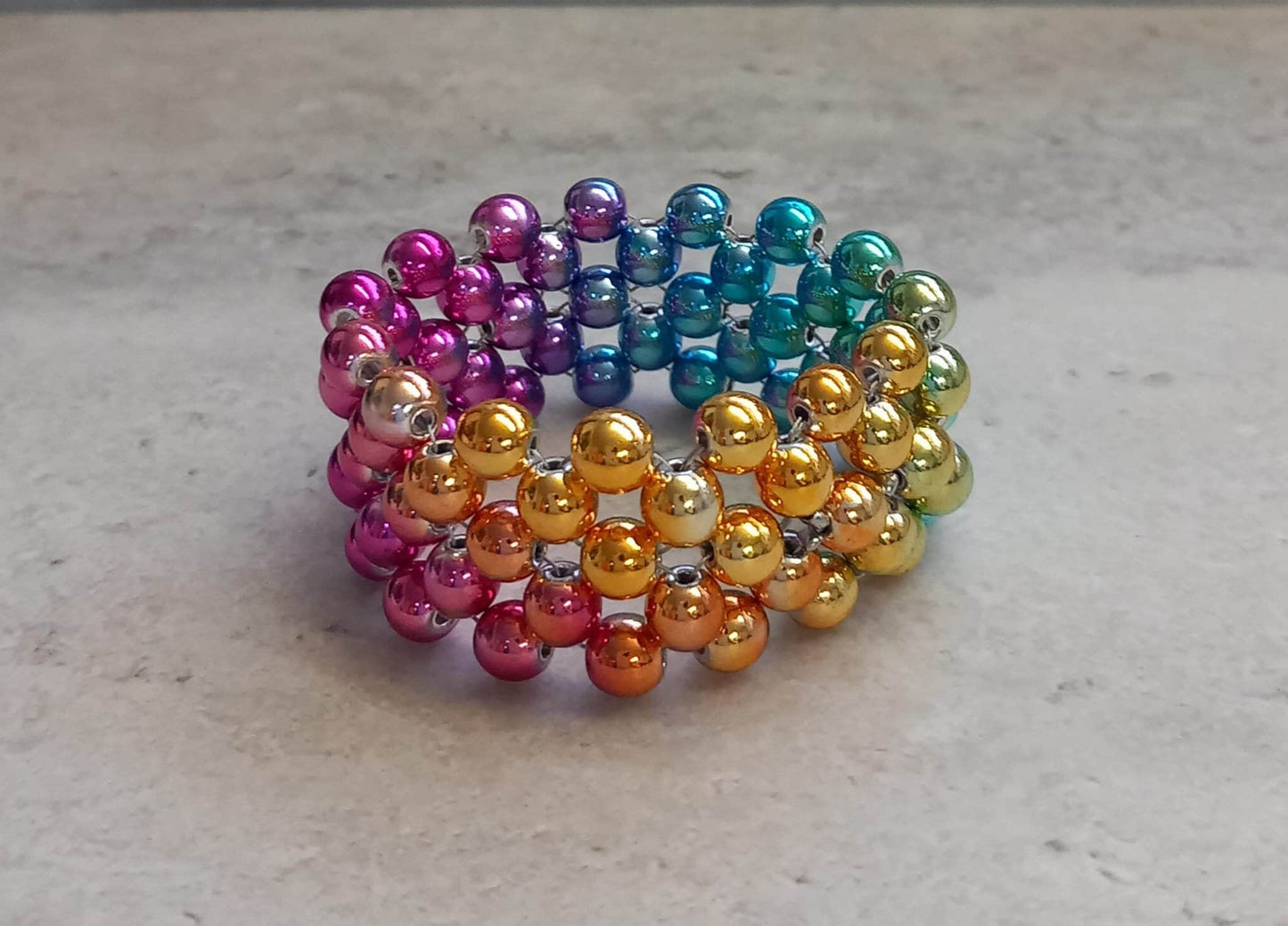 Penisring Masturbator 75 rotierende irisierende Regenbogen Hämatit - Perlen auf Chirurgenstahl Innen - Umfang ca 11,6cm - SEXSENSE