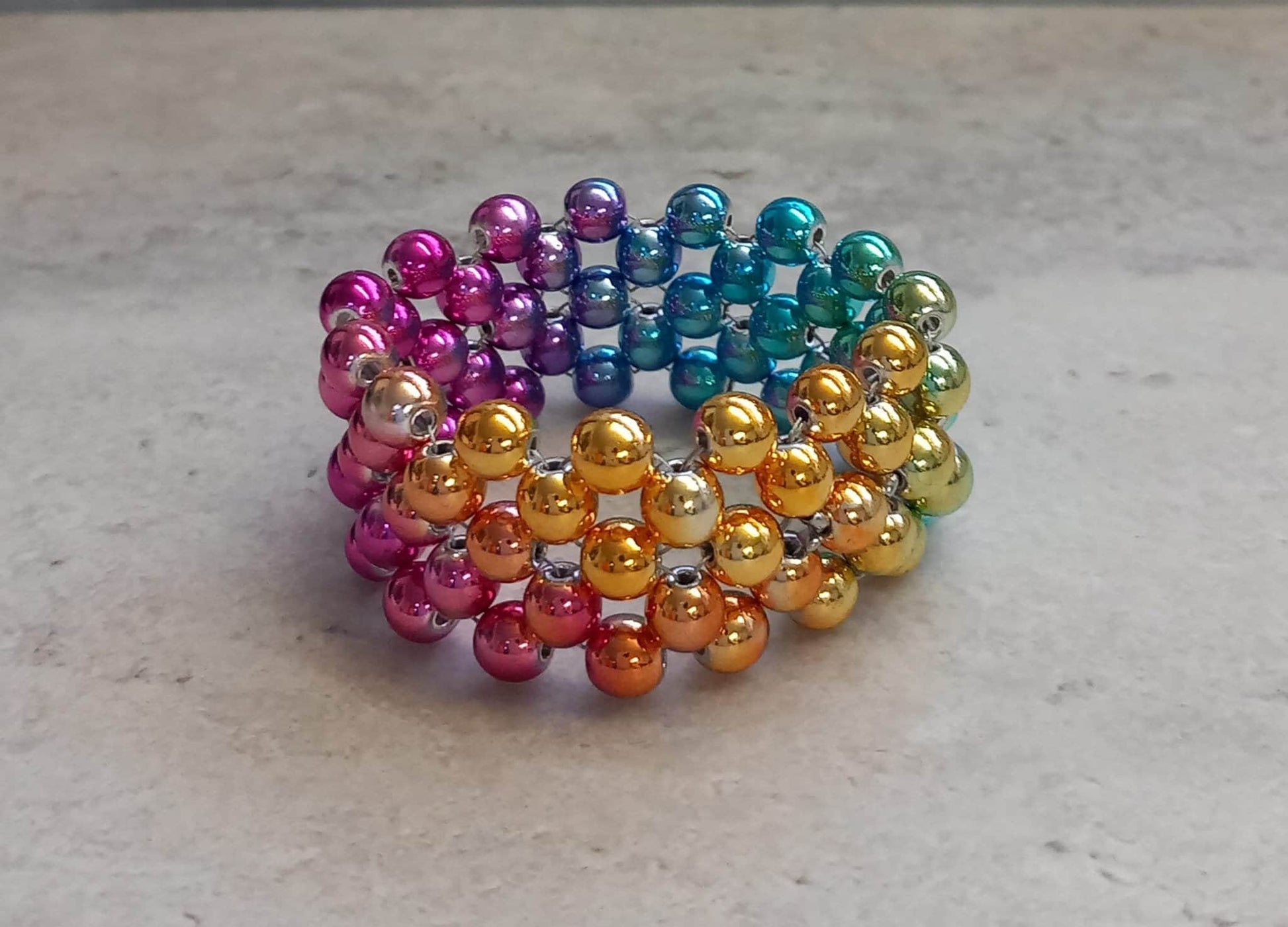 Penisring Masturbator 75 rotierende irisierende Regenbogen Hämatit - Perlen auf Chirurgenstahl Innen - Umfang ca 11,6cm - SEXSENSE